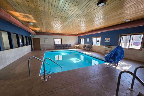 a swimming pool in a room with a large at Super 8 by Wyndham Hayward WI in Hayward