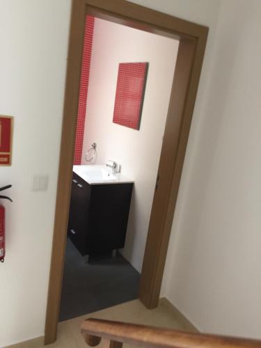 a bathroom with a sink and a mirror at Pateo Alfacinha in Lisbon