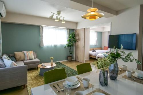 a living room with a couch and a table at Premium Apartment Hotel Tokyo East in Tokyo