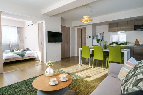 a living room and kitchen with a couch and a table at Premium Apartment Hotel Tokyo East in Tokyo