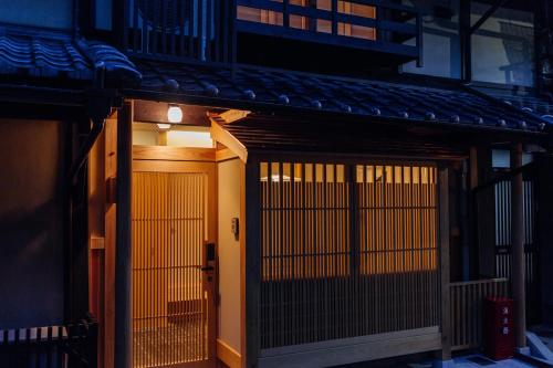 an entrance to a building with a gate at Kyomachiya Suite Rikyu in Kyoto