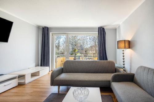 a living room with a couch and a window at Fewo Danzing in Quickborn