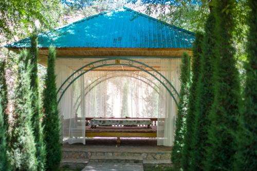 an archway with a bench in a park at HUMSON BULOQ SANATORIUM in Khumson