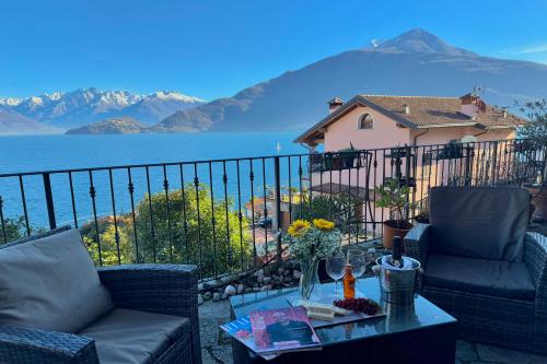 a balcony with a view of the water and a house at Pianello Bellavista in Pianello Del Lario