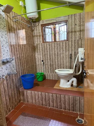a bathroom with a toilet and a shower at Native Homestay in Gokarna