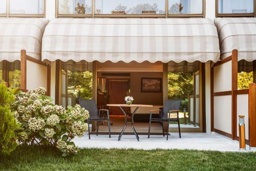 a patio with a table and chairs under an awning at Hilton Istanbul Bosphorus in Istanbul