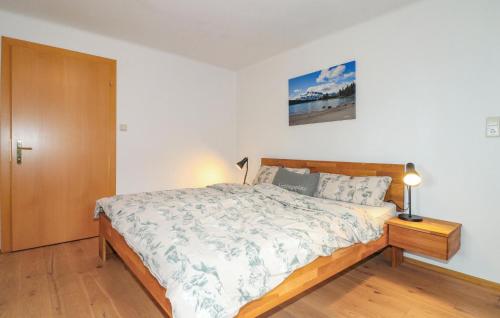 a bedroom with a large bed and a wooden door at Ferienwohnung In Sankt Koloman in Sankt Koloman