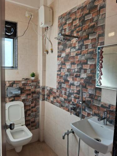 ein Badezimmer mit einer weißen Toilette und einem Waschbecken in der Unterkunft Wollywood, Wada in Wada