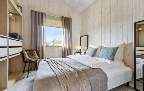 a bedroom with a large bed and a window at 4 Bedroom Nice Home In Højby in Højby