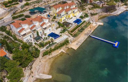 an aerial view of a house in the water at Cozy Apartment In Vidalici in Kustići