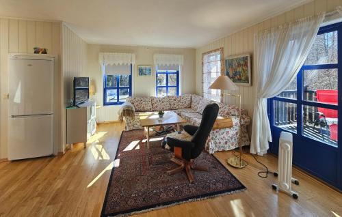a living room with a couch and a table at Cozy Apartment In Larkollen in Laurkollen