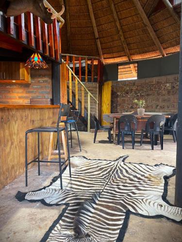 a zebra rug on the floor of a patio at Gecko Accommodation in Hotazel