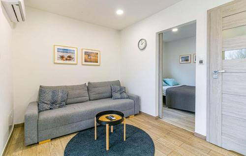 a living room with a couch and a bed at Cozy Apartment In Niechorze With Sauna in Niechorze