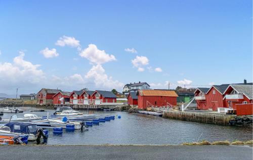 a group of boats docked in a harbor with houses at Lovely Apartment In Myklebost With Wifi in Myklebost