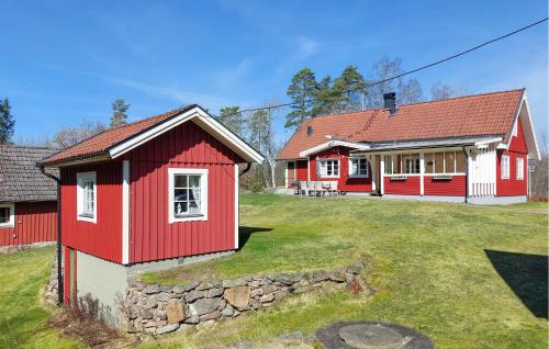 a red and white house with a yard at Nice Home In Vittsjö With Sauna in Vittsjö