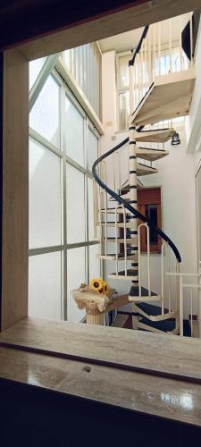 a room with a spiral staircase in a building at Affittacamere Girasole in Modugno