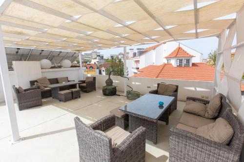 a patio with a table and chairs on a roof at Casa de São Bento by PURUS in Coimbra