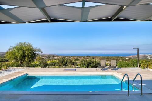 a swimming pool with a view of the ocean at Sternes Panorama Executive Villa with Pool, by Comfortbnb in Sitia