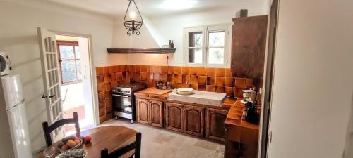 - une cuisine avec des placards en bois, une table et une cuisinière dans l'établissement La Campagne Provençale, à Le Val