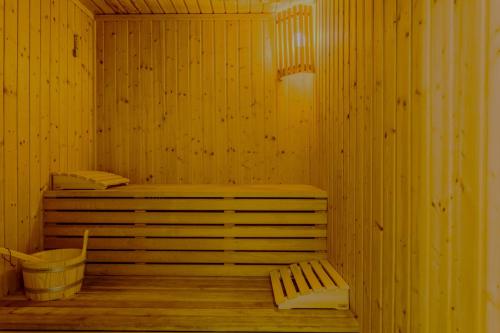 a wooden sauna with a bench and a tub at Kallisti Beach & Spa Villa - A Luxury Seaside Retreat in Lachi