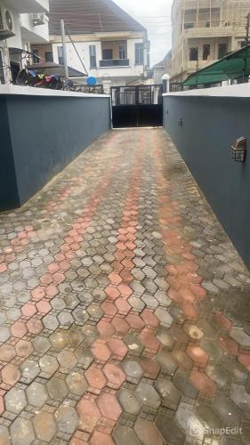 a walkway with red and brown bricks on a patio at SweetHomeVilla in Lekki