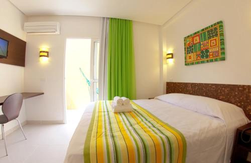 a bedroom with a bed with a stuffed animal on it at Pousada Eco Maceio in Maceió