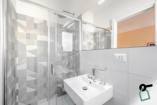 a white bathroom with a sink and a mirror at HOTIDAY Room Collection - Varazze in Varazze