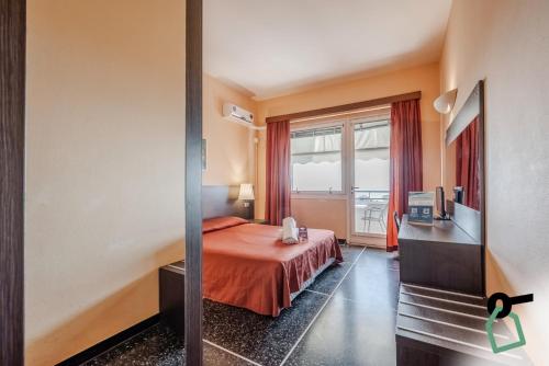 a hotel room with a bed and a window at HOTIDAY Room Collection - Varazze in Varazze
