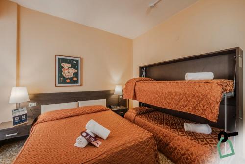 a hotel room with two beds with towels on them at HOTIDAY Room Collection - Varazze in Varazze