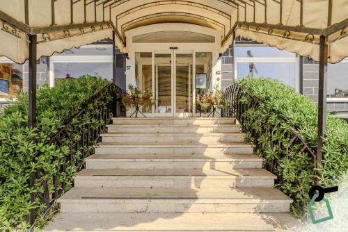 a stairway leading up to a house with a building at HOTIDAY Room Collection - Varazze in Varazze