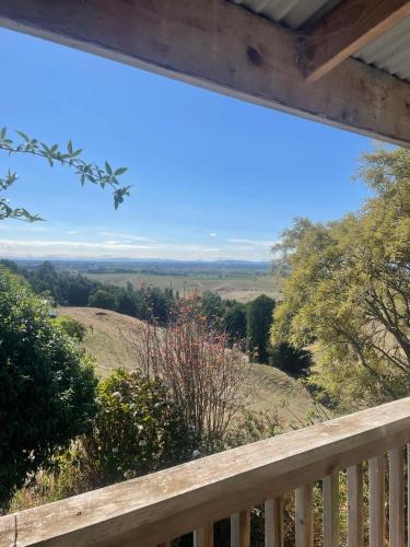 a view from the deck of a cabin with a view at Cosy Country Private Cottage with views in Harapepe