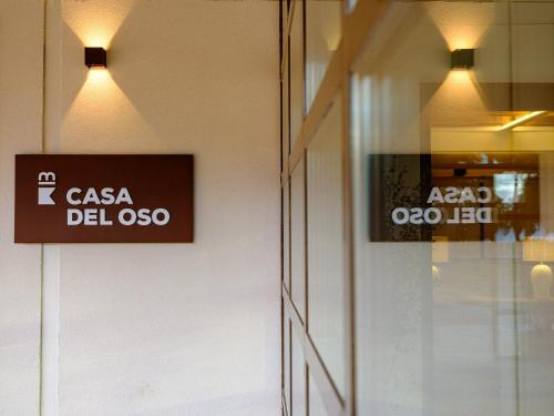 a sign on the side of a door of a store at Hotel Rural Casa del Oso in El Oso