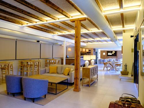 a living room with a couch and a table at Hotel Rural Casa del Oso in El Oso