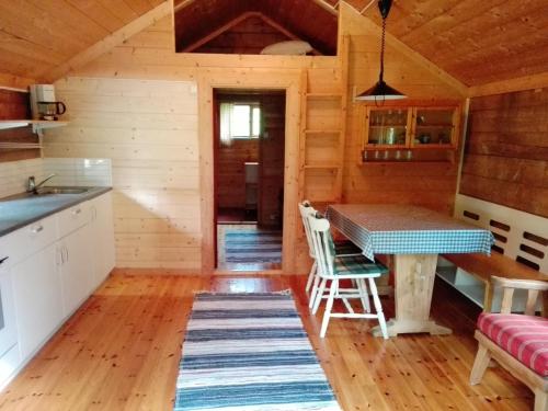 a kitchen and dining room of a log cabin at Vårsetra in Bø