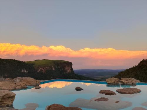 a blue pool of water on top of a mountain at Mosswood Bed & Breakfast in Graskop