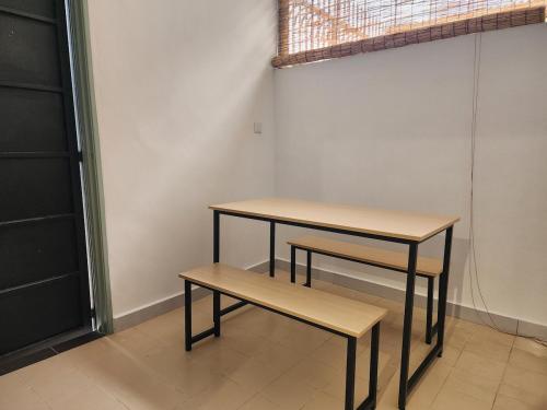 two tables and a bench in a room at Amazing Petaling Jaya Corner Landed Home Paradigm Mall, 5 Bedroom for up to 18Pax, LDP, Kelana Jaya, Paradigm Mall in Petaling Jaya
