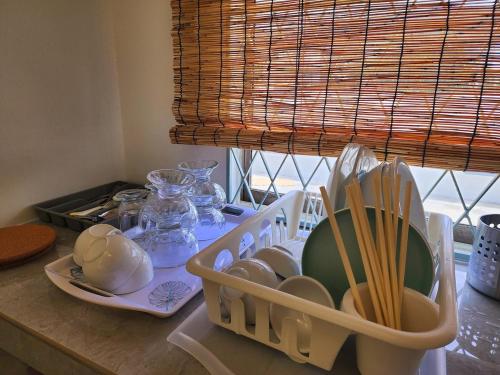 a kitchen counter with dishes and utensils on a table at Amazing Petaling Jaya Corner Landed Home Paradigm Mall, 5 Bedroom for up to 18Pax, LDP, Kelana Jaya, Paradigm Mall in Petaling Jaya
