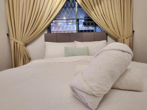 a bedroom with a white bed with a window at Amazing Petaling Jaya Corner Landed Home Paradigm Mall, 5 Bedroom for up to 18Pax, LDP, Kelana Jaya, Paradigm Mall in Petaling Jaya