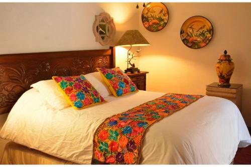 a bedroom with a bed with two pillows on it at Collection O Casa Bella Hotel Boutique, Cabo San Lucas in Cabo San Lucas