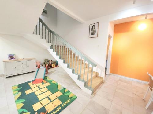 a living room with a staircase and a rug at Amazing Petaling Jaya Corner Landed Home Paradigm Mall, 5 Bedroom for up to 18Pax, LDP, Kelana Jaya, Paradigm Mall in Petaling Jaya
