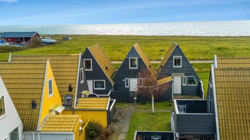 a row of houses with the ocean in the background at Family Holiday With Sea View In Gedser Feriepark in Gedser