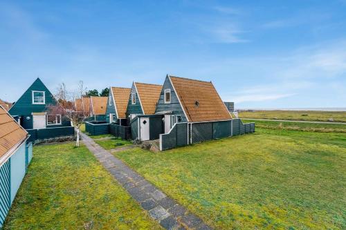a row of houses in a field with a yard at Family Holiday With Sea View In Gedser Feriepark in Gedser