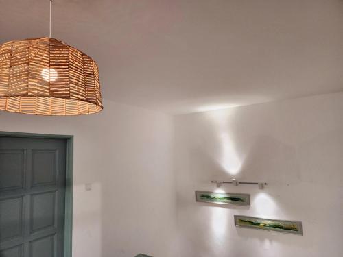 a pendant light hanging over a room with a door at Amazing Petaling Jaya Corner Landed Home Paradigm Mall, 5 Bedroom for up to 18Pax, LDP, Kelana Jaya, Paradigm Mall in Petaling Jaya