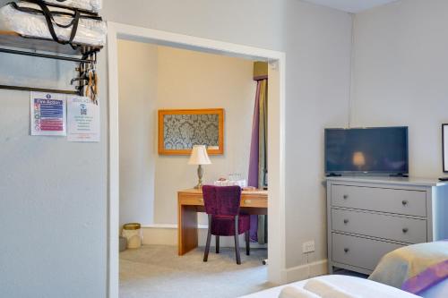 a bedroom with a desk and a bedroom with a bed at The County Hotel - Self Check-In, Ultra Fast WI-FI, Free Parking, Central Location in Selkirk