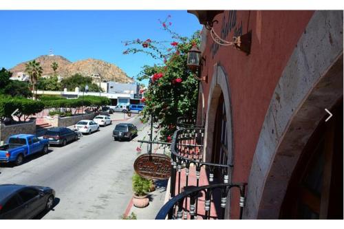 a balcony of a building with flowers on it at Collection O Casa Bella Hotel Boutique, Cabo San Lucas in Cabo San Lucas
