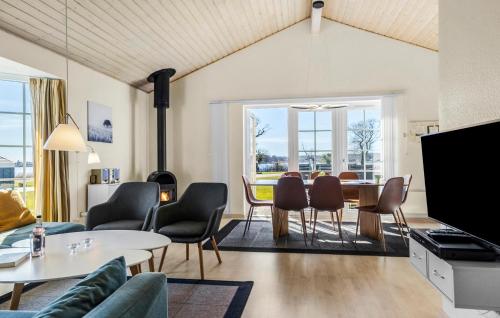 a living room with a table and chairs at Marina Fiskenæs Feriepark in Gråsten