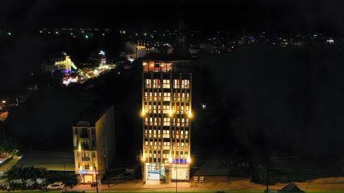 a tall building at night with lights on at Stellar Phú Quốc - Hotel in Phu Quoc