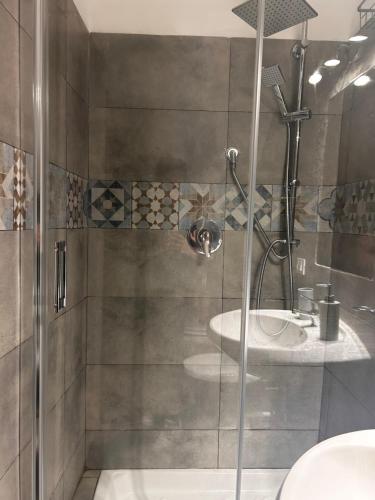 a bathroom with a shower with a toilet and a sink at Al Cortiletto in Palermo