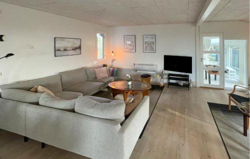 a living room with a couch and a table at Awesome Home In Millinge With Sauna in Millinge