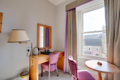 a room with a desk and a table and a window at The County Hotel - Self Check-In, Ultra Fast WI-FI, Free Parking, Central Location in Selkirk